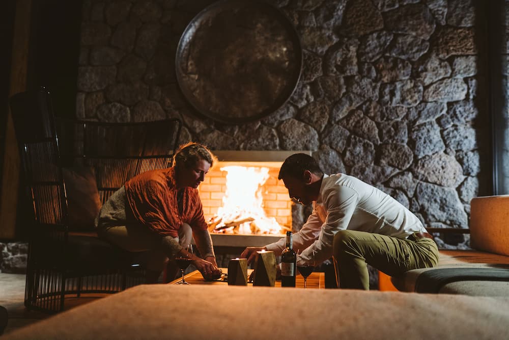 Singita Volcanoes National Park_Board game by the fire_BlackBean